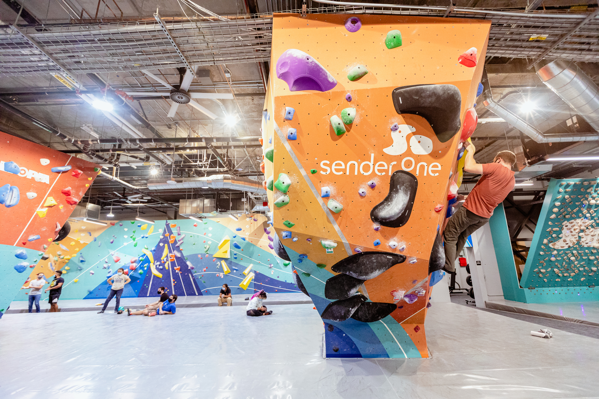 Large group of people in front of a climbing wall