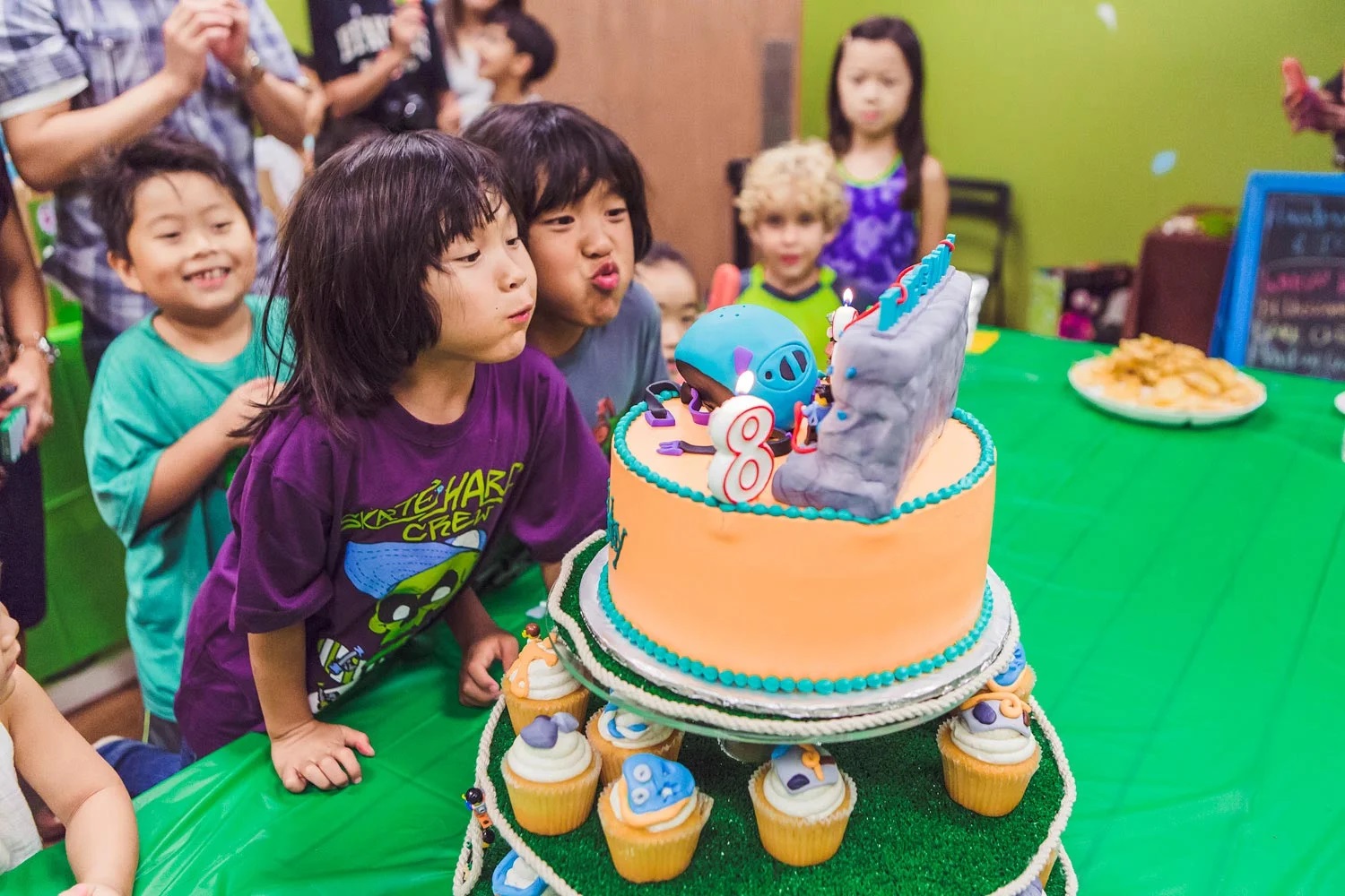 Young people looking at a cake during a birthday party at Sender City