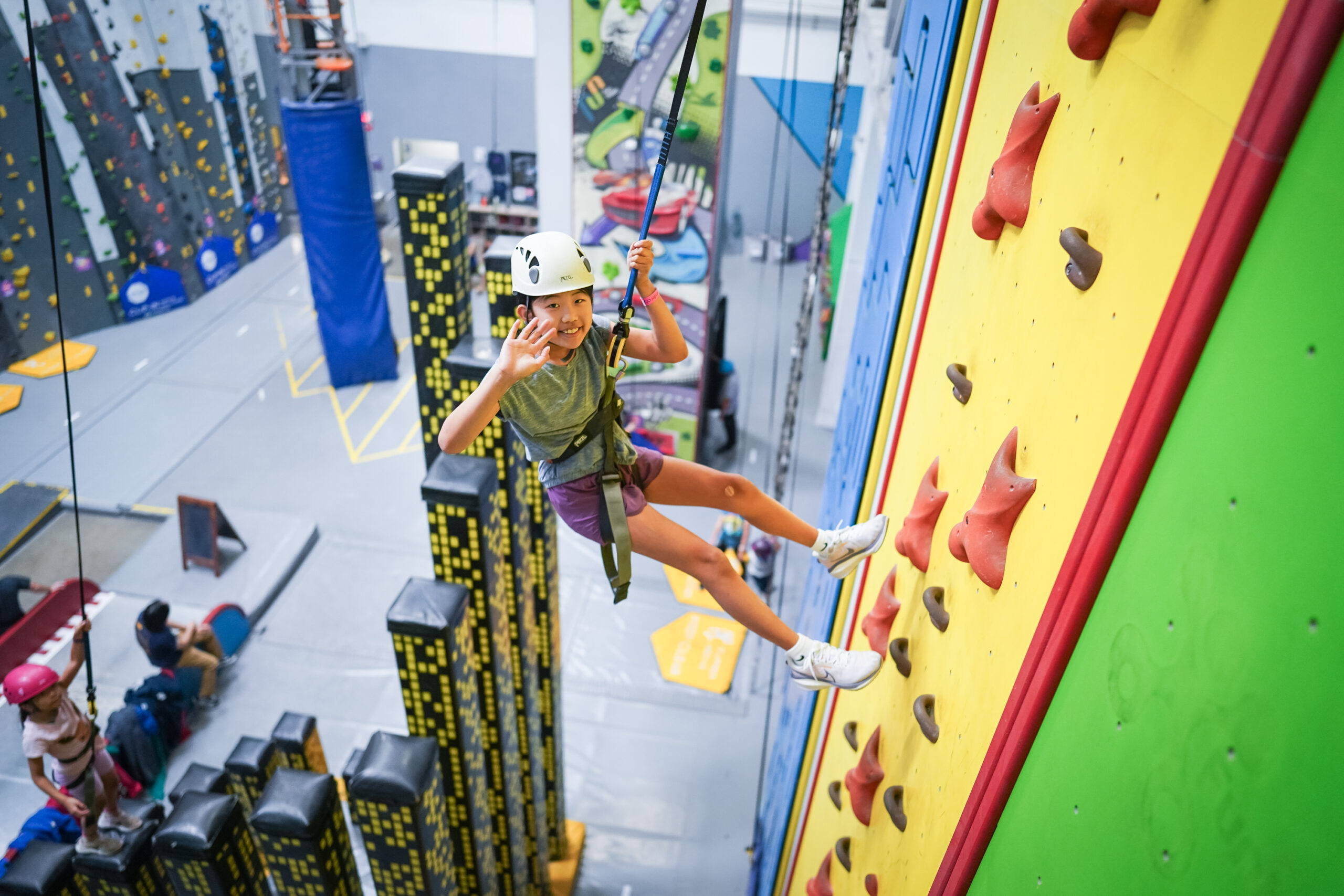 Youth on a rope climbing in Sender City