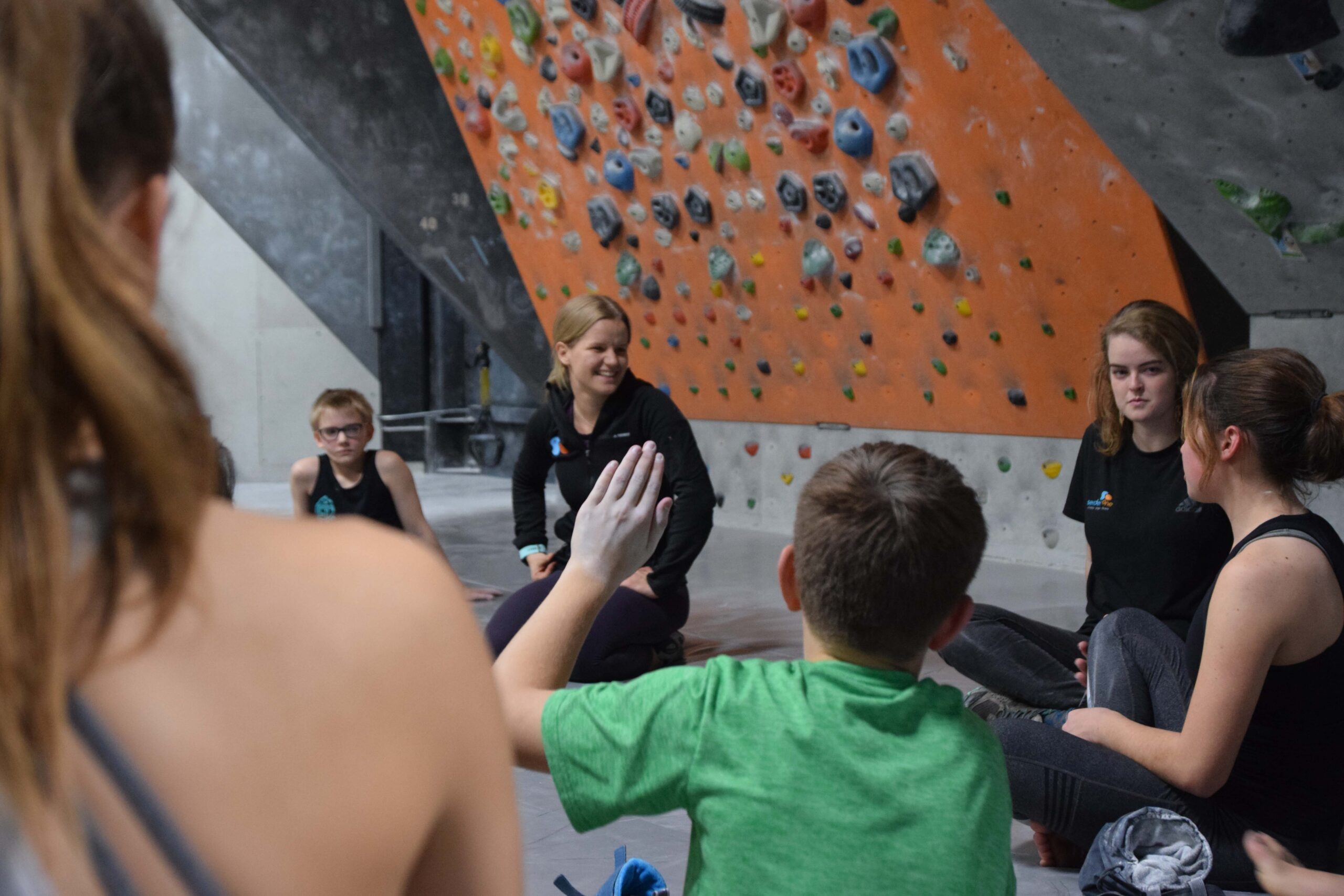 Group of climbers in front of a climbing wall